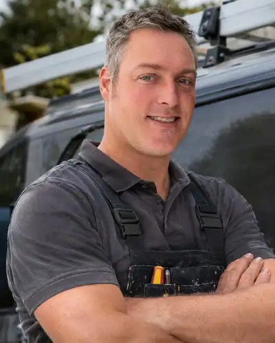 Railton, the handyman behind Brighton Installations, standing by his van